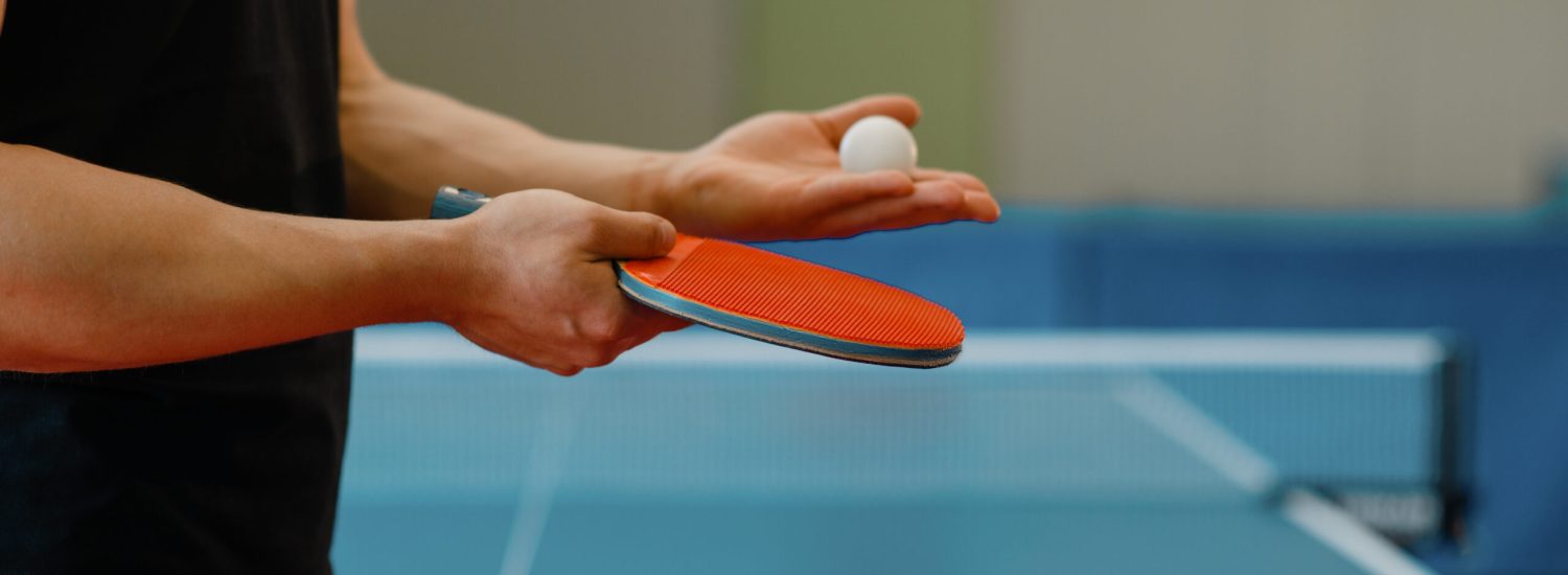 Male person hands with ping pong racket and ball